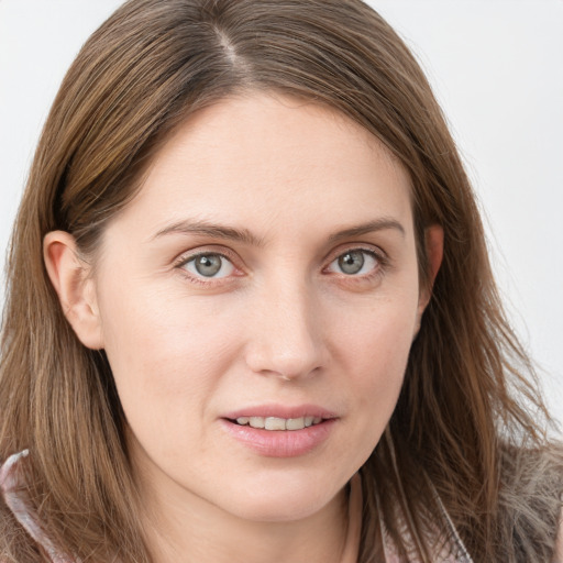 Joyful white young-adult female with long  brown hair and grey eyes