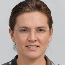 Joyful white adult female with medium  brown hair and grey eyes