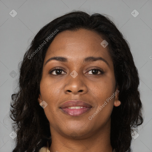 Joyful black young-adult female with long  brown hair and brown eyes