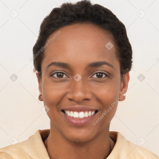 Joyful black young-adult female with short  brown hair and brown eyes