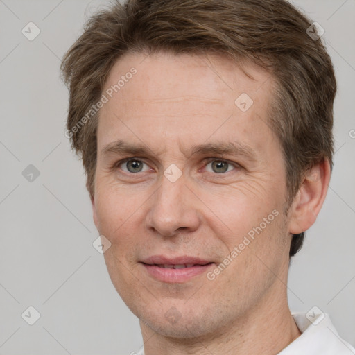 Joyful white adult male with short  brown hair and grey eyes