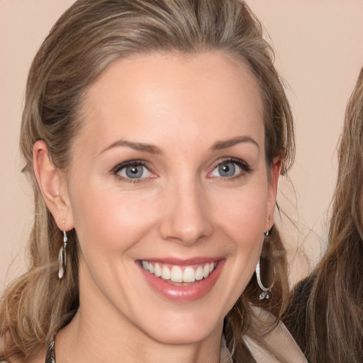 Joyful white young-adult female with long  brown hair and grey eyes