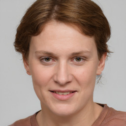 Joyful white young-adult female with medium  brown hair and blue eyes