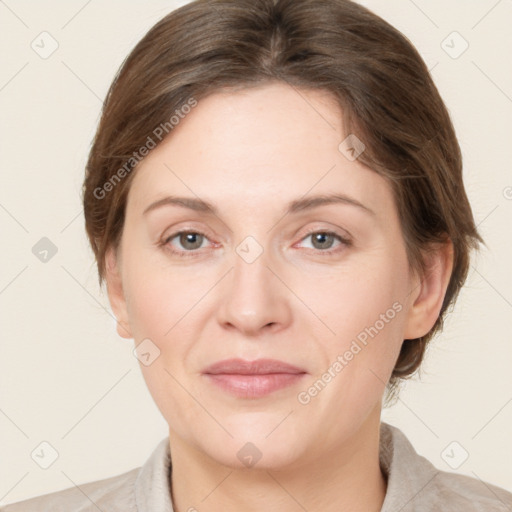 Joyful white adult female with medium  brown hair and grey eyes