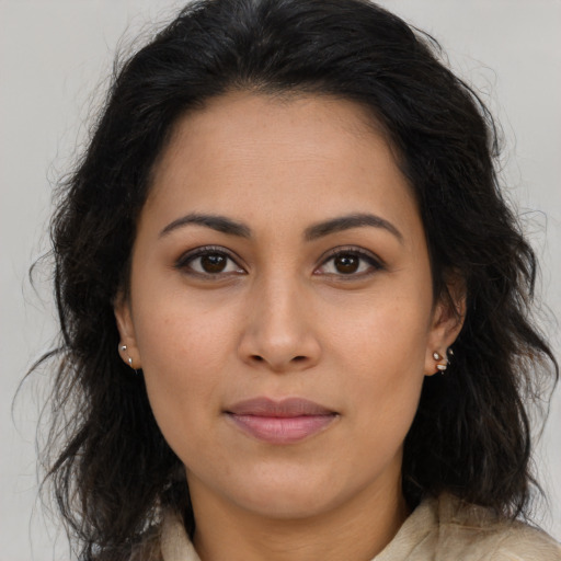 Joyful latino young-adult female with long  brown hair and brown eyes