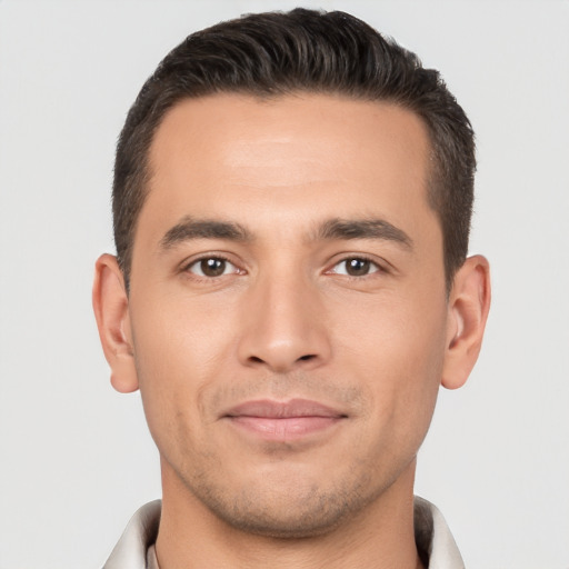 Joyful white young-adult male with short  brown hair and brown eyes