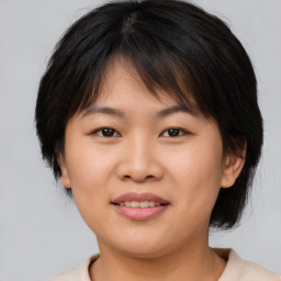 Joyful asian young-adult female with medium  brown hair and brown eyes