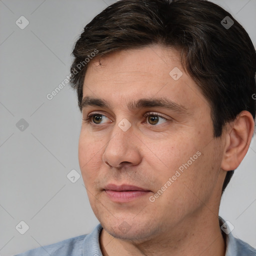 Joyful white adult male with short  brown hair and brown eyes