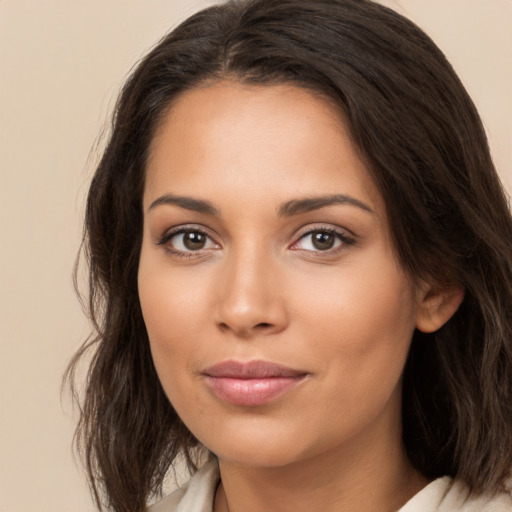 Joyful white young-adult female with long  brown hair and brown eyes