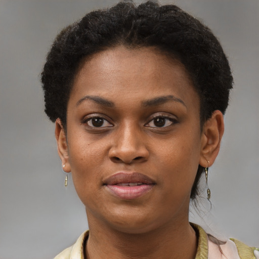Joyful black young-adult female with short  brown hair and brown eyes
