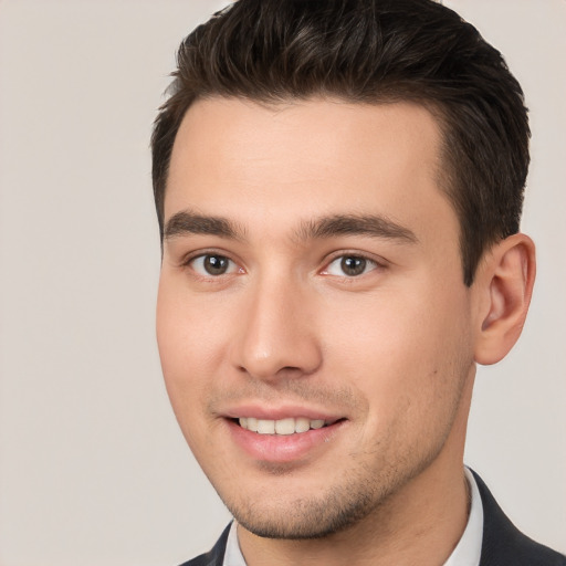 Joyful white young-adult male with short  brown hair and brown eyes