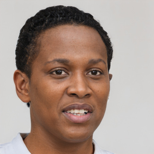 Joyful black young-adult female with short  brown hair and brown eyes