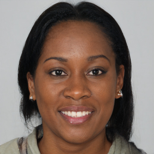 Joyful black young-adult female with medium  brown hair and brown eyes