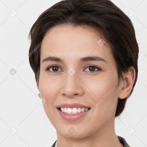 Joyful white young-adult female with short  brown hair and brown eyes