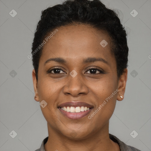 Joyful black young-adult female with short  black hair and brown eyes