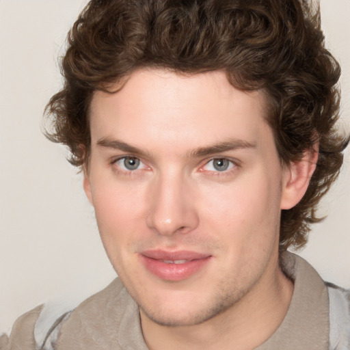 Joyful white young-adult male with medium  brown hair and brown eyes