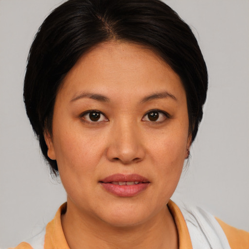 Joyful asian young-adult female with medium  brown hair and brown eyes