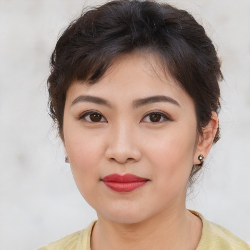 Joyful asian young-adult female with medium  brown hair and brown eyes