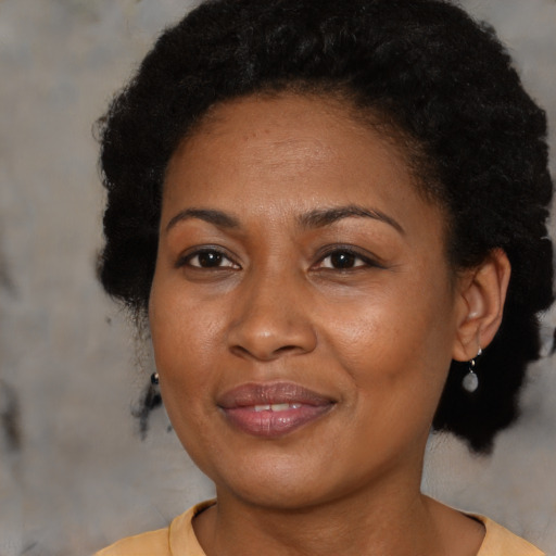 Joyful black adult female with short  brown hair and brown eyes
