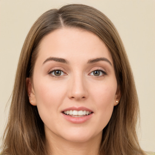 Joyful white young-adult female with long  brown hair and brown eyes