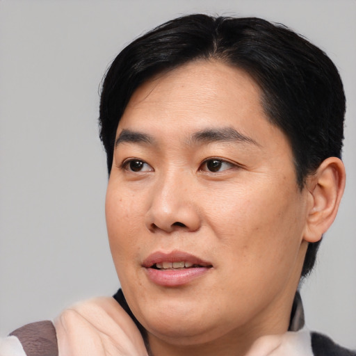 Joyful asian young-adult male with medium  black hair and brown eyes