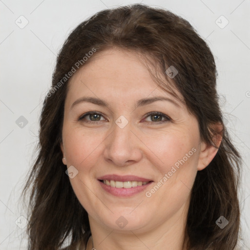 Joyful white adult female with long  brown hair and brown eyes