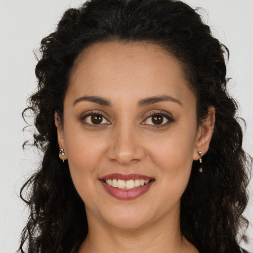 Joyful white young-adult female with long  brown hair and brown eyes