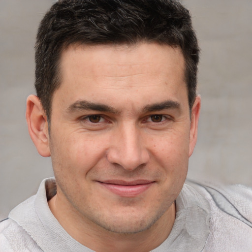 Joyful white adult male with short  brown hair and brown eyes