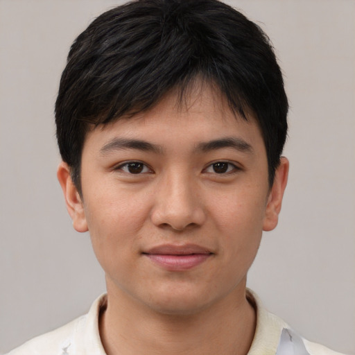 Joyful asian young-adult male with short  brown hair and brown eyes