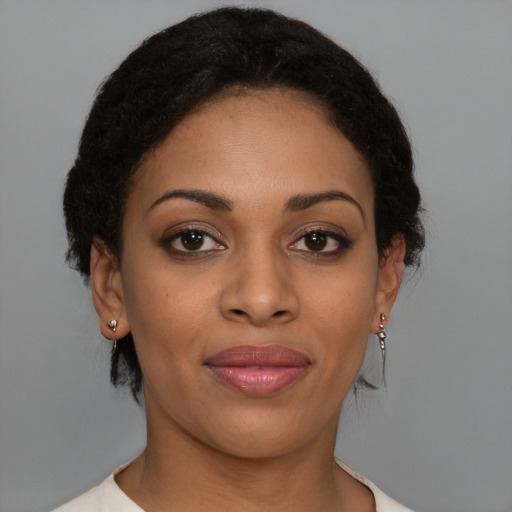 Joyful black young-adult female with short  brown hair and brown eyes
