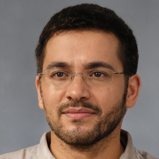 Joyful white adult male with short  brown hair and brown eyes