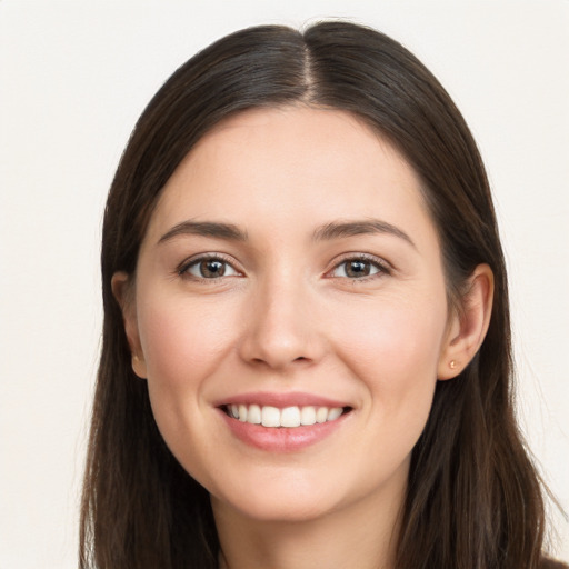 Joyful white young-adult female with long  brown hair and brown eyes