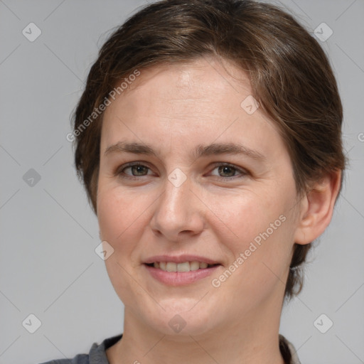 Joyful white adult female with medium  brown hair and grey eyes