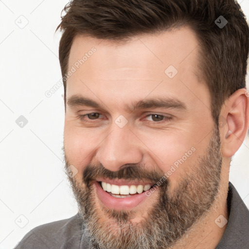 Joyful white adult male with short  brown hair and brown eyes