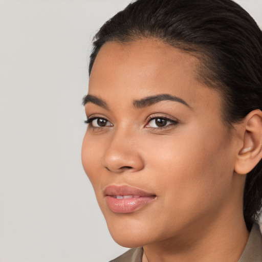 Joyful latino young-adult female with medium  brown hair and brown eyes