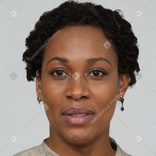 Joyful black adult female with short  black hair and brown eyes