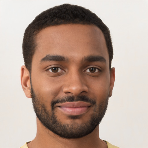 Joyful black young-adult male with short  brown hair and brown eyes