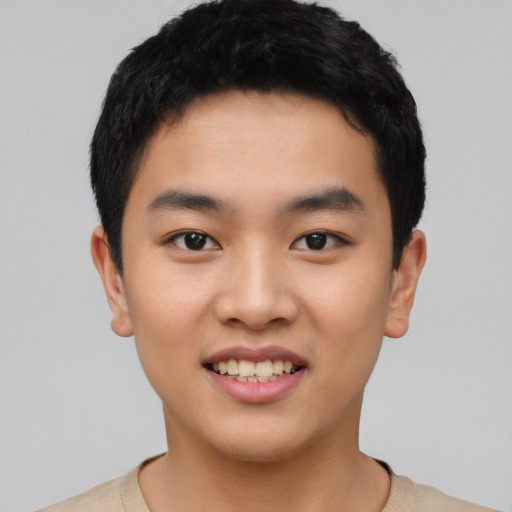 Joyful asian young-adult male with short  black hair and brown eyes