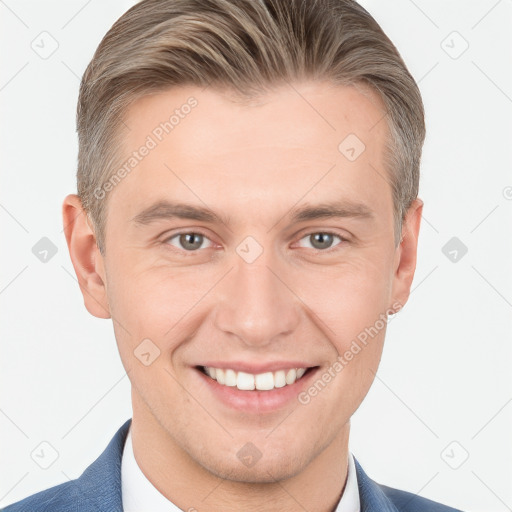 Joyful white young-adult male with short  brown hair and grey eyes