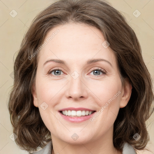 Joyful white young-adult female with medium  brown hair and green eyes