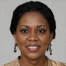 Joyful black adult female with medium  brown hair and brown eyes