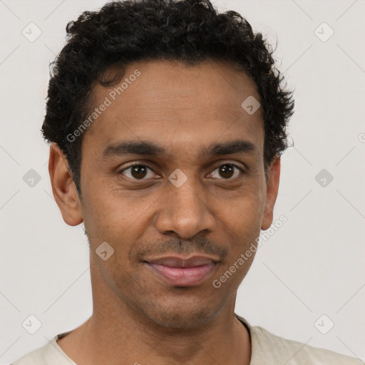 Joyful black young-adult male with short  brown hair and brown eyes