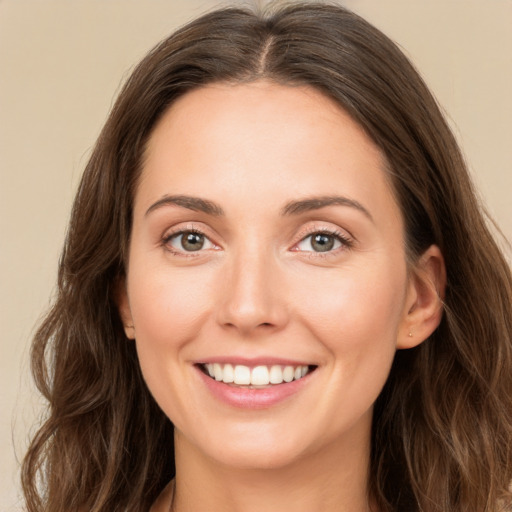 Joyful white young-adult female with long  brown hair and green eyes