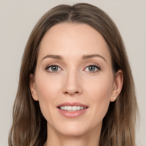 Joyful white young-adult female with long  brown hair and grey eyes