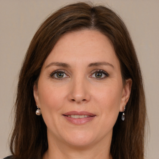 Joyful white young-adult female with long  brown hair and green eyes