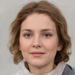 Joyful white young-adult female with medium  brown hair and blue eyes