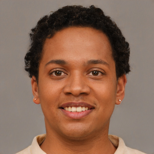 Joyful black young-adult female with short  brown hair and brown eyes