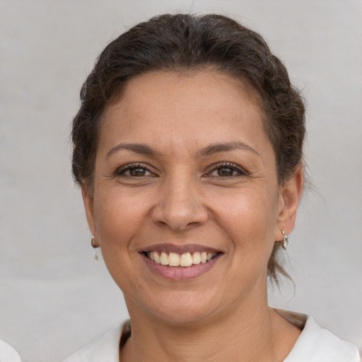 Joyful white adult female with short  brown hair and brown eyes