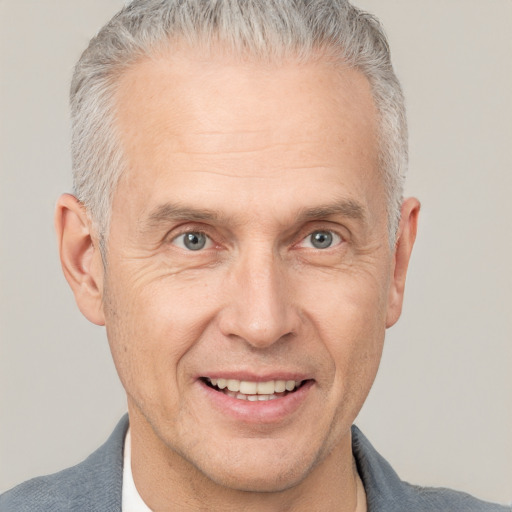 Joyful white middle-aged male with short  gray hair and brown eyes