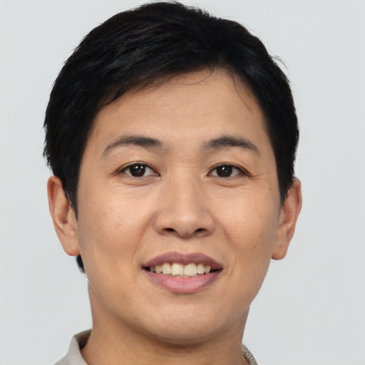 Joyful asian young-adult female with short  brown hair and brown eyes